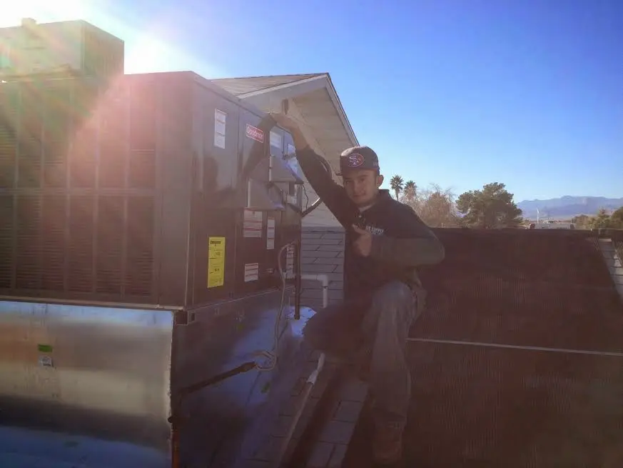 HVAC technician performing AC Tune-Up on a rooftop unit in Gettysburg